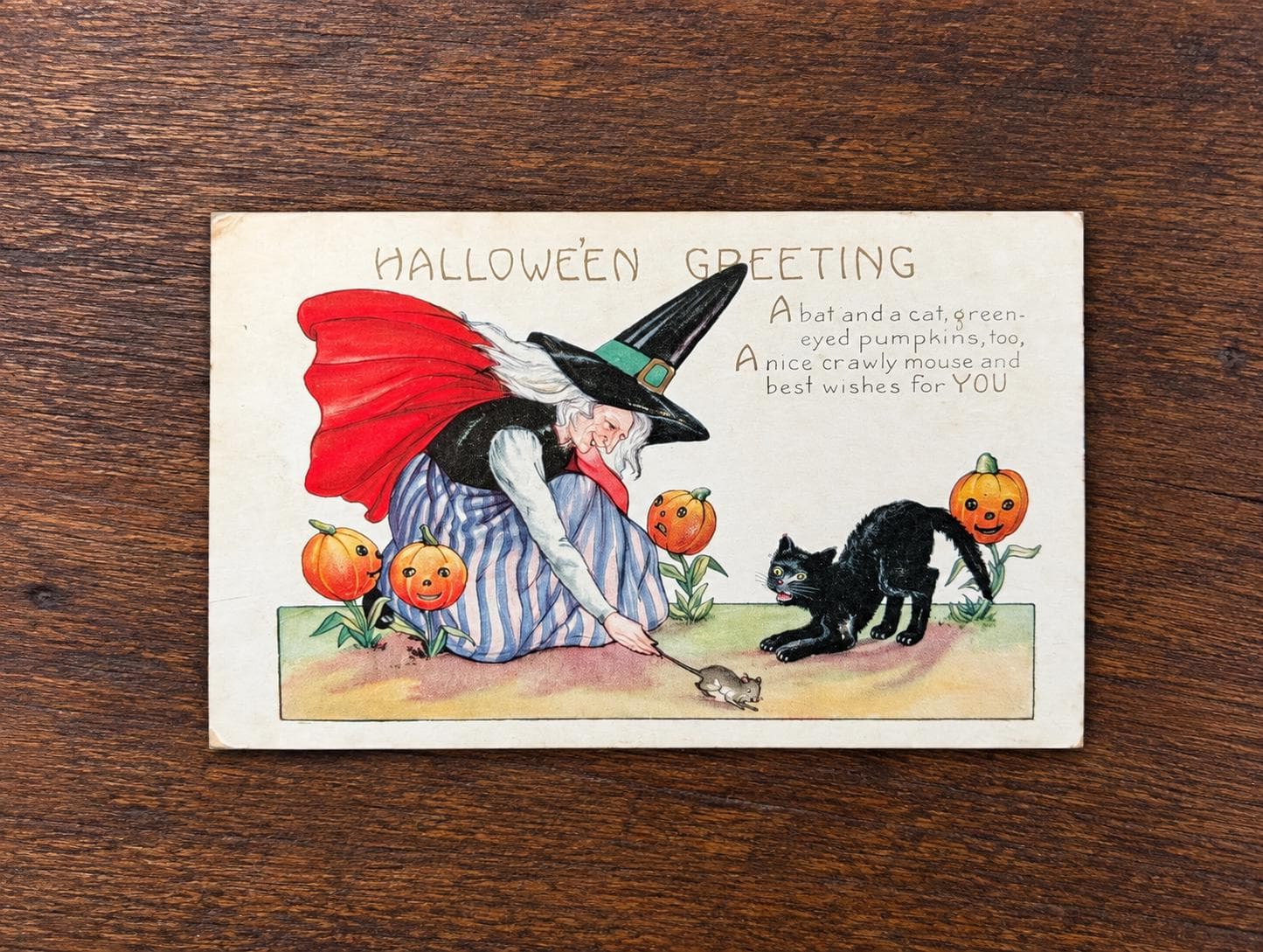 1925 Whitney Made Halloween postcard showing a witch, black cat, jack-o'-lanterns and a mouse